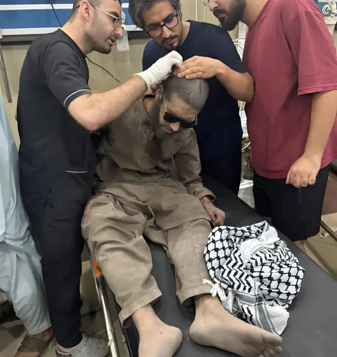 A pakistani Man is getting first aid treatment during rocket attack from india on sindoor operation